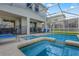 Inviting screened-in pool and spa area with outdoor seating, perfect for relaxation and entertaining at 1565 Mulligan Blvd, Davenport, FL 33896