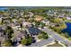 Scenic aerial view showcasing the house with mature trees and landscaping, as well as the layout of the surrounding neighborhood at 16003 Tangerine Blossom Way, Winter Garden, FL 34787