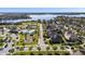 Community aerial view showcasing a pool, playground, tennis courts, and a scenic lake at 16003 Tangerine Blossom Way, Winter Garden, FL 34787