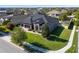 Aerial view of a gray house with a manicured lawn and a three-car garage at 16003 Tangerine Blossom Way, Winter Garden, FL 34787