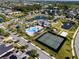 Aerial view of the community including the pool, a park, pond, and tennis courts at 16003 Tangerine Blossom Way, Winter Garden, FL 34787
