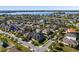 Expansive aerial showcasing the residential neighborhood next to a tranquil lake, highlighting the community's serene and natural setting at 16003 Tangerine Blossom Way, Winter Garden, FL 34787