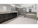 Modern bathroom with double vanity, tiled shower, and soaking tub at 16003 Tangerine Blossom Way, Winter Garden, FL 34787