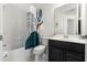 Cozy bathroom features a shower-tub combination with a colorful shower curtain and modern vanity at 16003 Tangerine Blossom Way, Winter Garden, FL 34787