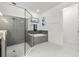 Bright bathroom featuring a glass-enclosed shower and separate tub with contemporary tile and stylish fixtures at 16003 Tangerine Blossom Way, Winter Garden, FL 34787