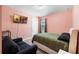 Inviting bedroom with pink walls, large tv, and comfortable bed at 16003 Tangerine Blossom Way, Winter Garden, FL 34787