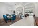 Open-concept dining room with view to kitchen, living room and white tile floors at 16003 Tangerine Blossom Way, Winter Garden, FL 34787
