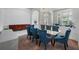 Bright dining room with blue velvet chairs, modern light fixture, and view to the entrance at 16003 Tangerine Blossom Way, Winter Garden, FL 34787