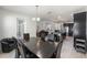 Open concept dining room with view of the kitchen and living room has contemporary finishes and plenty of seating at 16003 Tangerine Blossom Way, Winter Garden, FL 34787