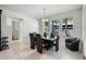 Dining area with modern table, six chairs, and natural light from large windows at 16003 Tangerine Blossom Way, Winter Garden, FL 34787