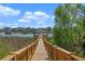 Wooden dock with lake view providing access to the tranquil waters and serene surroundings at 16003 Tangerine Blossom Way, Winter Garden, FL 34787