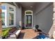 Charming front porch area with comfortable seating and decorative touches by the entryway at 16003 Tangerine Blossom Way, Winter Garden, FL 34787