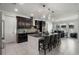 Spacious kitchen with a large island, dark cabinets, pendant lights, and white tile flooring at 16003 Tangerine Blossom Way, Winter Garden, FL 34787