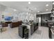 Open-concept kitchen featuring island seating and a view to the living room at 16003 Tangerine Blossom Way, Winter Garden, FL 34787