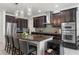 Gourmet kitchen featuring dark wood cabinets, wine fridge, and stainless steel appliances at 16003 Tangerine Blossom Way, Winter Garden, FL 34787