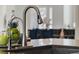 Close up of a modern kitchen faucet with decor at 16003 Tangerine Blossom Way, Winter Garden, FL 34787