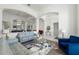 Spacious living room with large arched openings, modern decor, and a cozy seating arrangement at 16003 Tangerine Blossom Way, Winter Garden, FL 34787