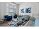 Comfortable living room with modern furnishings, and tall windows, enhancing natural light at 16003 Tangerine Blossom Way, Winter Garden, FL 34787