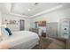 Comfortable main bedroom has neutral carpet, dresser, large bed, and bright decor at 16003 Tangerine Blossom Way, Winter Garden, FL 34787