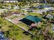 Aerial view of a fenced playground with shade covering, swings, and slides with lush green grass at 16003 Tangerine Blossom Way, Winter Garden, FL 34787