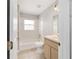 Functional bathroom featuring tub, shower, tiled floor and a wooden vanity cabinet at 177 Larch Rd, Ocala, FL 34480
