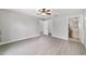 Spacious bedroom with laminate floors, ceiling fan, closet, and attached bathroom at 177 Larch Rd, Ocala, FL 34480