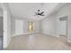 Bright living room showcases neutral paint, tile floors, and a ceiling fan, with views to other rooms at 177 Larch Rd, Ocala, FL 34480