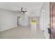 Spacious living area with tile flooring and neutral walls, connecting to a sliding glass door to backyard at 177 Larch Rd, Ocala, FL 34480