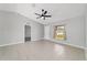 Open-concept living room features neutral paint, vaulted ceilings, ceiling fan, and plenty of natural light at 177 Larch Rd, Ocala, FL 34480