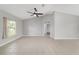 Spacious living room featuring neutral tones, vaulted ceilings, tile flooring, and a bright window view at 177 Larch Rd, Ocala, FL 34480