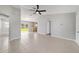 Open-concept living area boasts tile flooring, neutral paint, and sliding glass doors to the backyard at 177 Larch Rd, Ocala, FL 34480