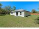This home has a spacious backyard, bordered by mature trees and a wood fence at 18 Pine Pass Ln, Ocala, FL 34472