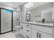 Modern bathroom featuring a dual vanity, granite countertops, and a luxurious walk-in shower at 18 Pine Pass Ln, Ocala, FL 34472