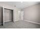 Comfortable bedroom with neutral carpet, an open closet, and an en suite bathroom at 18 Pine Pass Ln, Ocala, FL 34472
