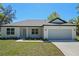 Beautiful single-story home with a two-car garage and well-maintained lawn at 18 Pine Pass Ln, Ocala, FL 34472