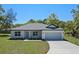 Charming single-story home featuring a two-car garage and freshly landscaped front yard at 18 Pine Pass Ln, Ocala, FL 34472