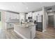 Modern kitchen with white cabinets, stainless steel appliances, and a granite-topped center island at 18 Pine Pass Ln, Ocala, FL 34472