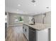 Modern kitchen island with stainless steel dishwasher, granite counters, and black faucet at 18 Pine Pass Ln, Ocala, FL 34472