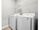 Convenient laundry room with side-by-side washer and dryer and wire shelving at 18 Pine Pass Ln, Ocala, FL 34472
