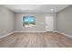 Bright and open living room with laminate flooring and a large window offering plenty of natural light at 18 Pine Pass Ln, Ocala, FL 34472