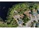 A birds-eye perspective showcases a home nestled on a beautiful lot adjacent to a pristine lake at 209 Roman Ct, Deltona, FL 32738