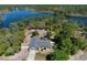 An aerial view of a charming home bordered by lake and trees, showcasing its serene and natural surroundings at 209 Roman Ct, Deltona, FL 32738