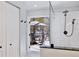 Modern bathroom boasting a sleek shower with white subway tile and views of the screened-in patio with lake at 209 Roman Ct, Deltona, FL 32738