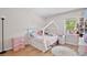 Bright bedroom featuring wood flooring, a house frame bed with decorative lights, and a window with natural light at 209 Roman Ct, Deltona, FL 32738