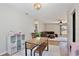 Dining area with a view to the living room featuring a wooden table and storage at 209 Roman Ct, Deltona, FL 32738