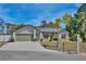 Inviting single-story home with a well-kept lawn, mature tree, and a paved driveway leading to an attached garage at 209 Roman Ct, Deltona, FL 32738