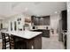 Stylish kitchen featuring quartz countertops, dark cabinetry, stainless steel appliances, and modern fixtures at 209 Roman Ct, Deltona, FL 32738