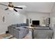 Comfortable living room with a large sectional couch, entertainment center, and natural light at 209 Roman Ct, Deltona, FL 32738