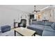 Open concept living room flows into the kitchen, featuring a sectional and an easy chair at 209 Roman Ct, Deltona, FL 32738