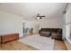 Cozy living room with a comfortable couch, ottoman, and a warm, inviting atmosphere at 209 Roman Ct, Deltona, FL 32738